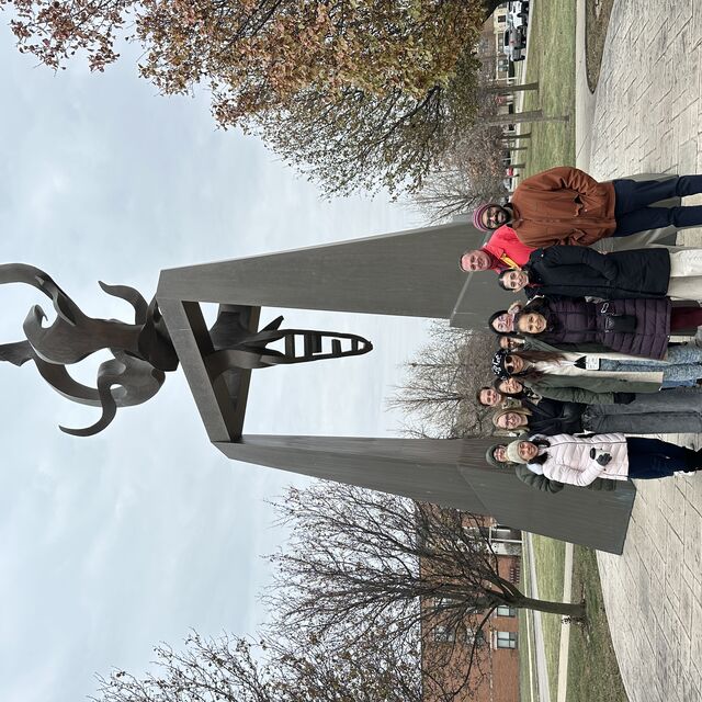 Group in front of a big statue
